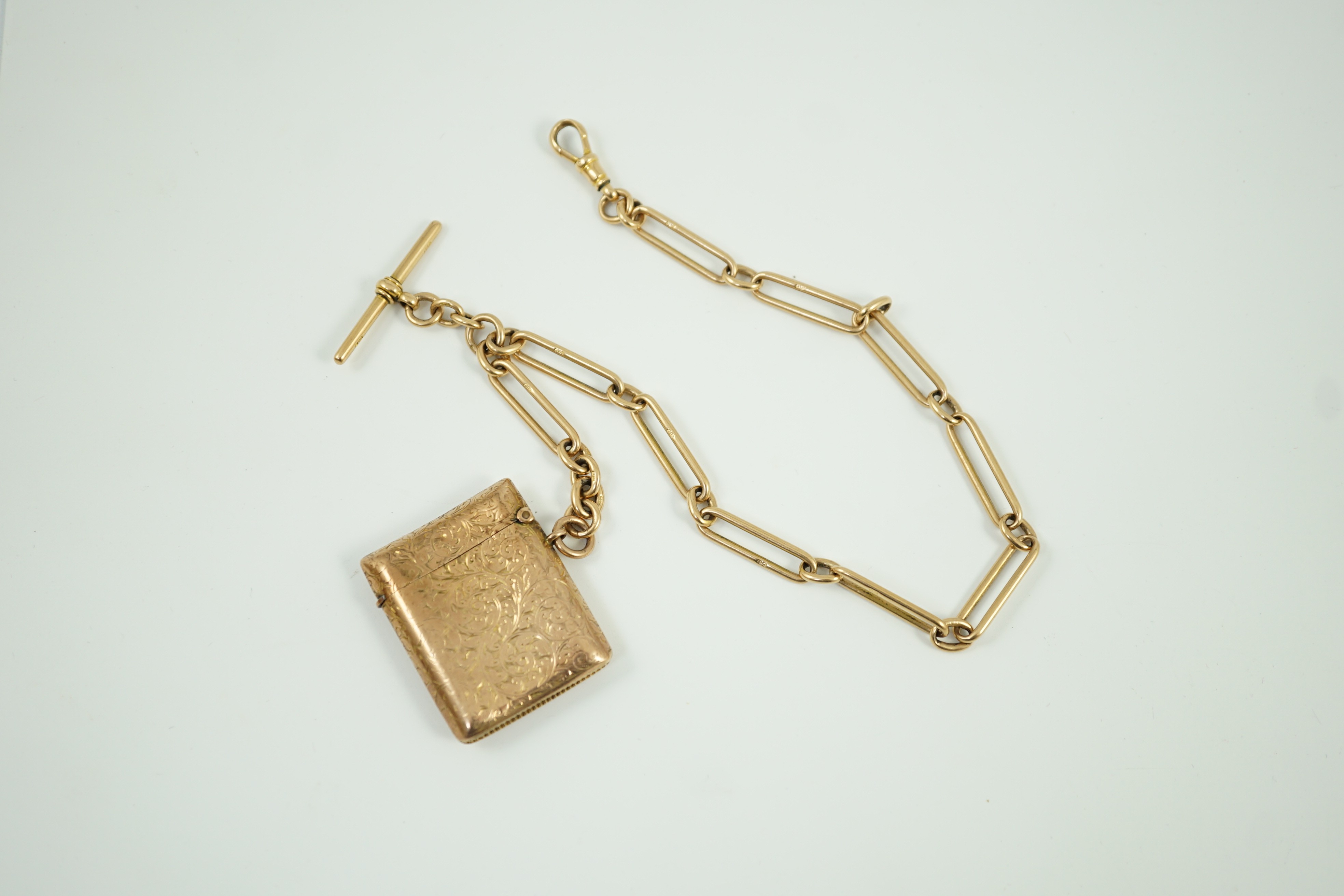 An Edwardian engraved 9ct gold vesta case, 44mm, gross 20.6 grams, together with an 18ct gold albert, 34cm, 45.8 grams.